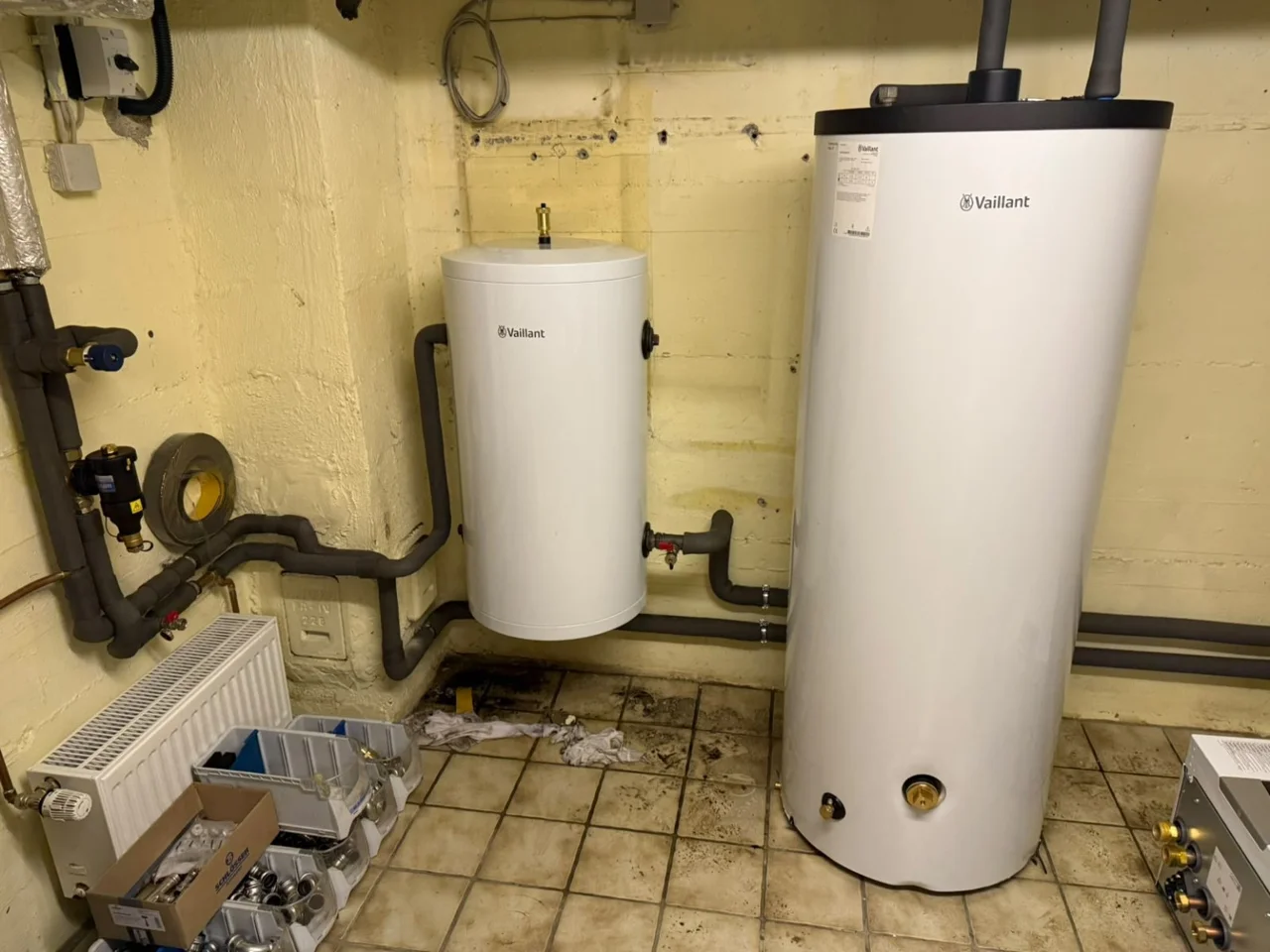 Neue Speicher und Leitungsanschlüsse für das Wärmepumpensystem im Heizraum